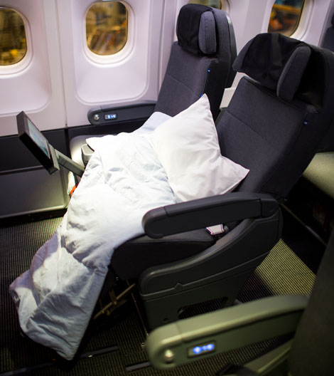 Business class seat with bedding